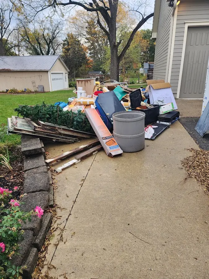 Dumpster being loaded with debris for 12 Yard Dumpster Rental in Roscommon